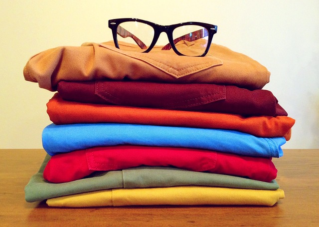 složené oblečení a brýle